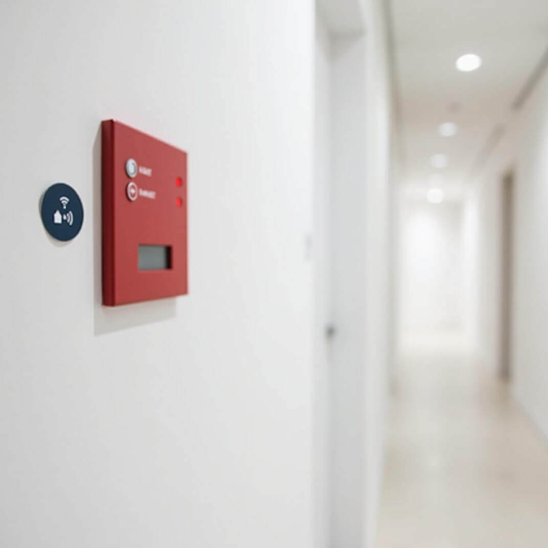 WiseBlock NFC tag next to fire alarm panel in building corridor